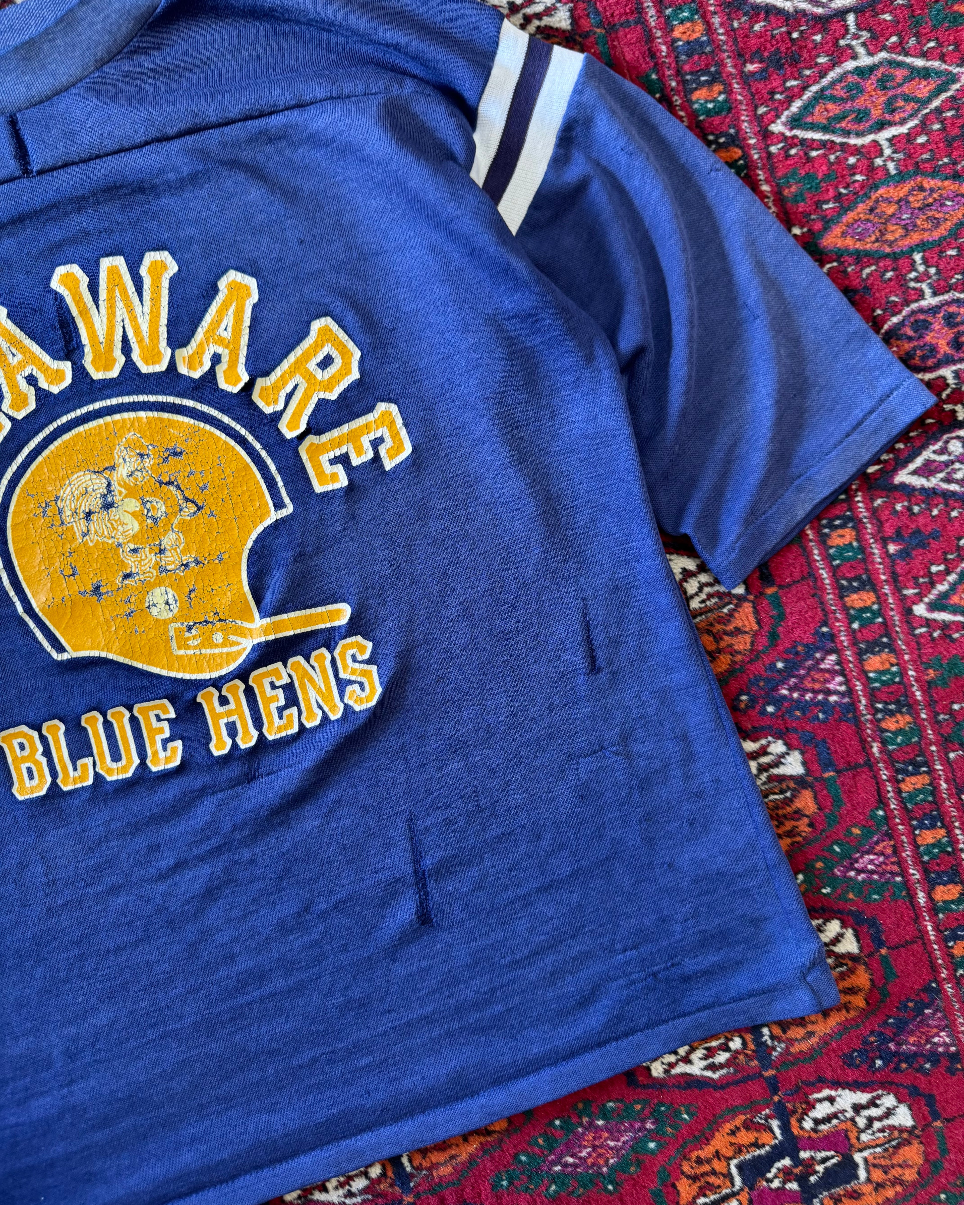Vintage faded distressed, two tone Delaware blue hens jersey